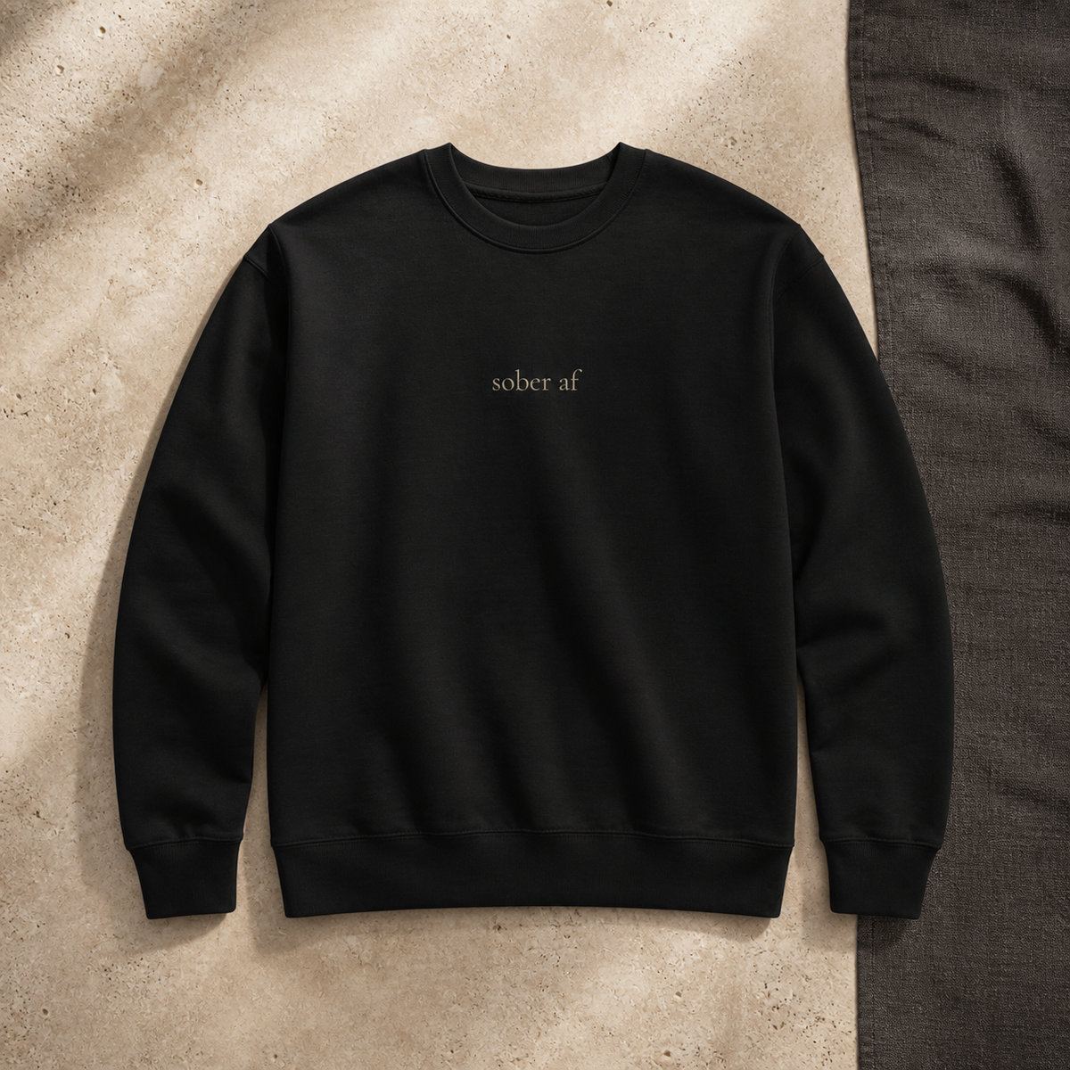 SOBER AF crewneck in Black on warm travertine