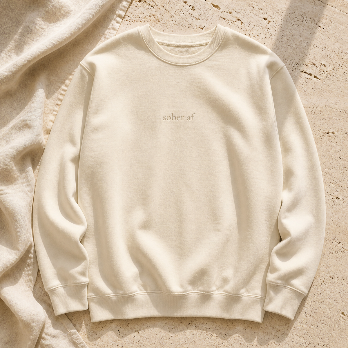 SOBER AF crewneck in Bone on warm travertine