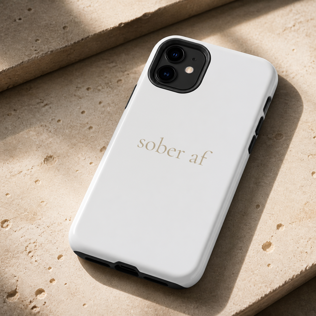 SOBER AF glossy white iPhone case on travertine