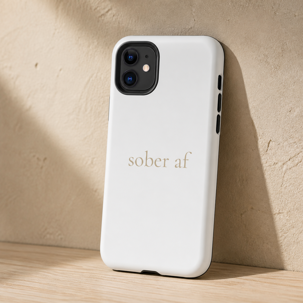 SOBER AF matte white iPhone case on pale oak