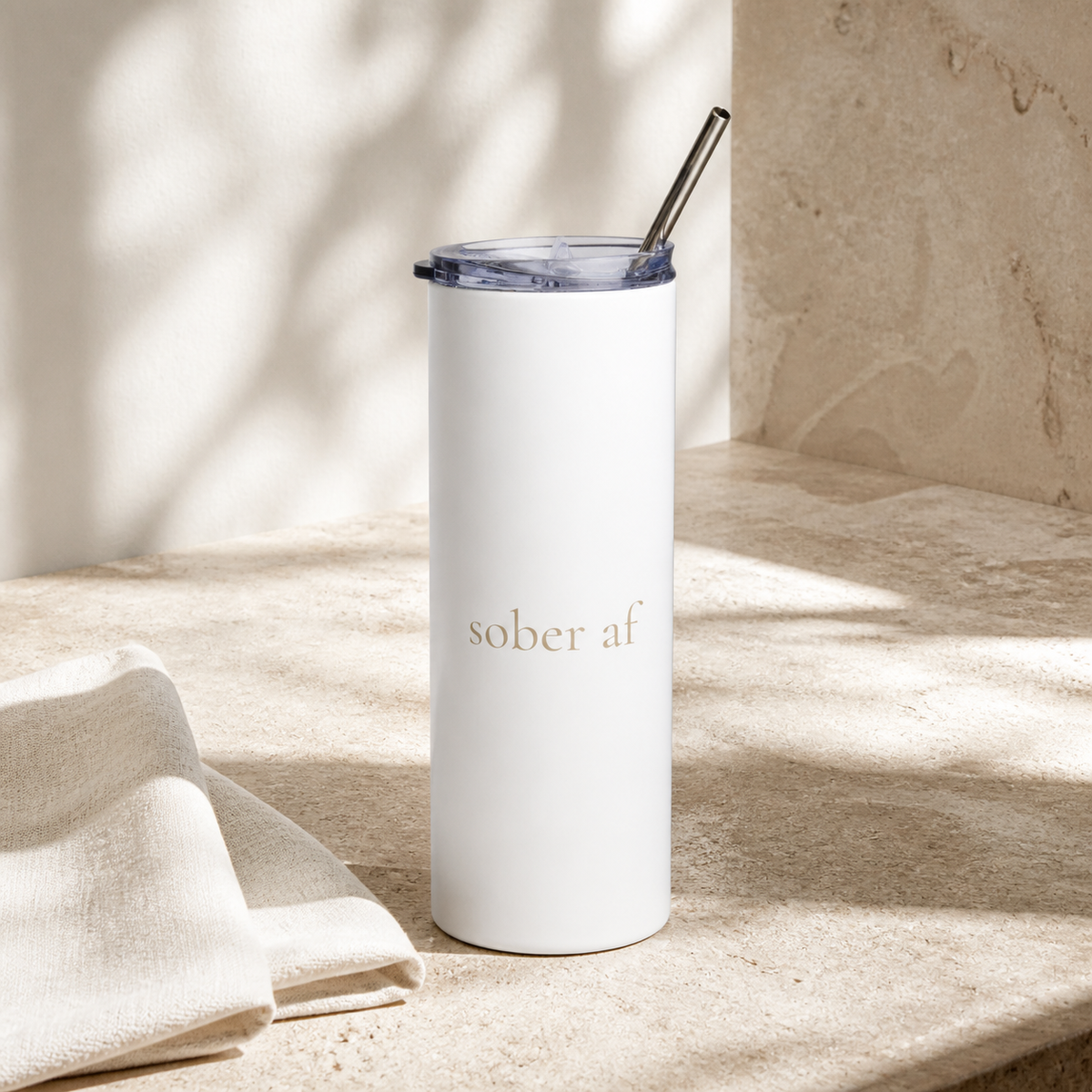 SOBER AF white tumbler with cream linen on travertine